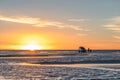 Happy tourists enjoy Sunset during four wheel tour in Salt flat Lake Salar de Uyuni in Bolivia Royalty Free Stock Photo